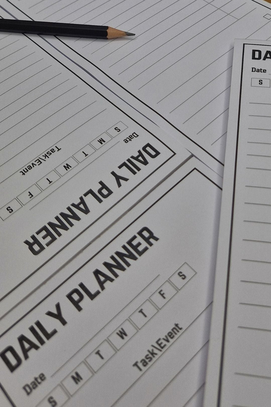 Daily planner sheet with a pencil on a wooden surface