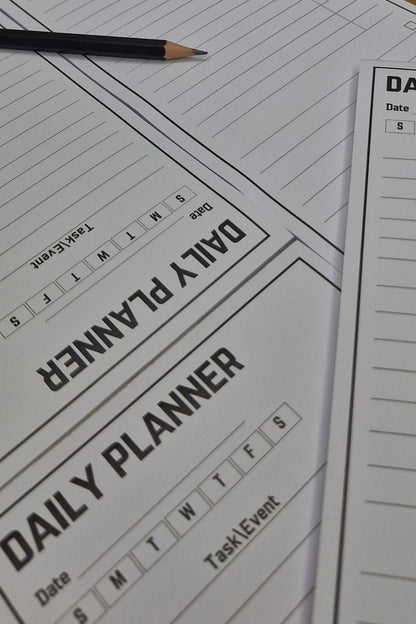 Daily planner sheet with a pencil on a wooden surface