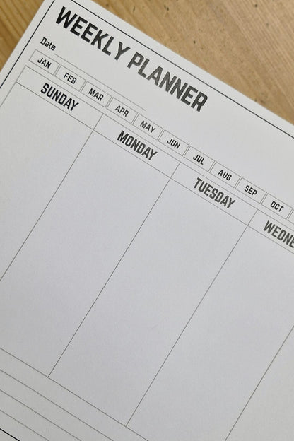 Weekly planner sheet on a wooden surface