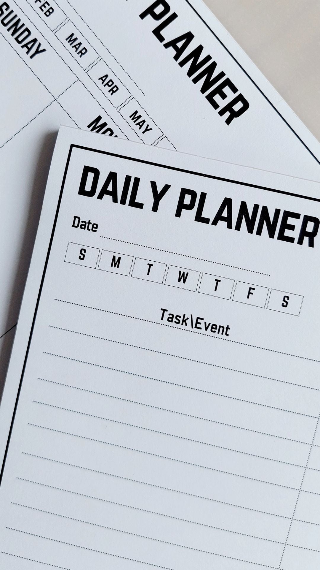 Daily planner with task/event columns on a white surface