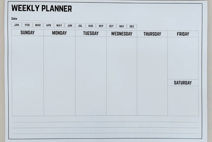 Weekly planner sheet with days of the week on a white background